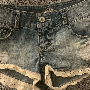 Light blue Jean shorts with beautiful white ruffle on the bottom.
